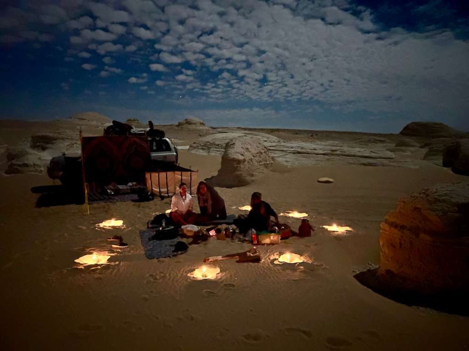 Camp under a star-filled desert sky
